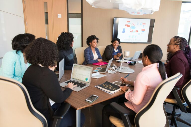 Diverse team engaging in a productive business meeting in a modern office setting.